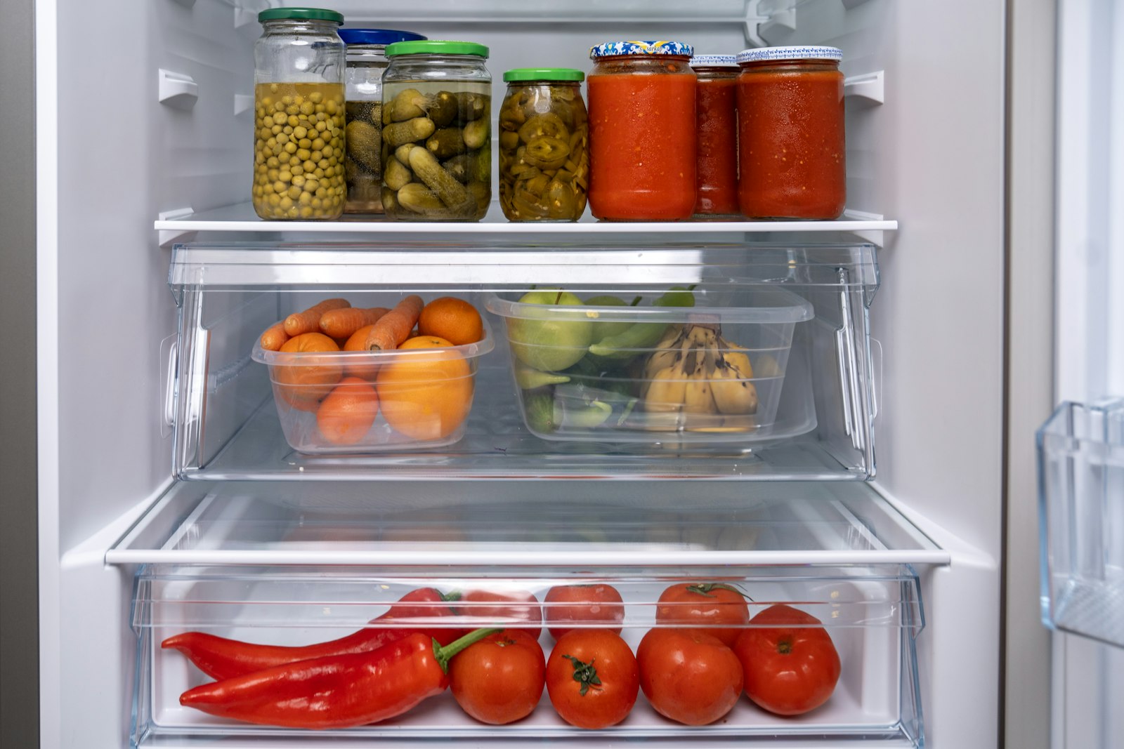 Clear refrigerator drawers holding fresh vegetables