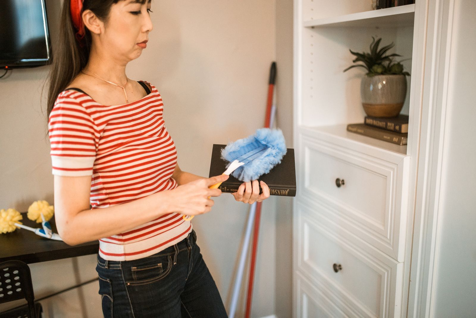 Microfiber duster collecting household dust